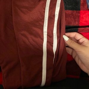 Maroon leggings with 2 white stripes